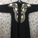 Nida front open gown abaya with intricate embroidery on the front and sleeves, offering a stylish and elegant design.