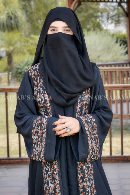 Front Open Abaya in Black Color featuring embroidery on front and sleeves cuffs as well as motive on scarf crafted in Imported Nida Korean Fabric.