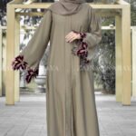 Front Open Abaya in Skin Color With Cut & Pearl Work on Sleeves with Red & White Pearl Combination.