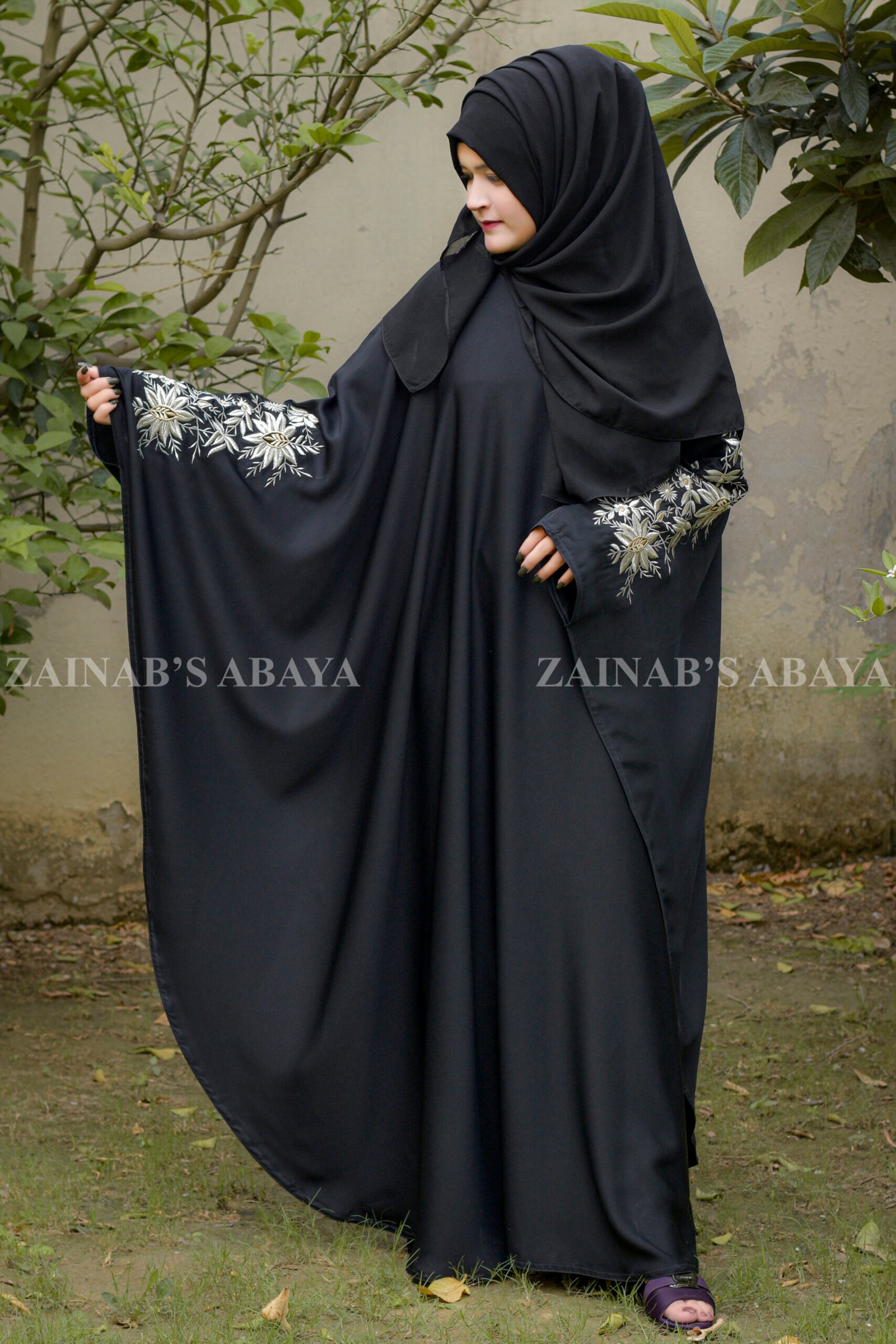 Kaftan Abaya Black Kaftan Abaya in Nida Korean Fabric with Tilla Embroidery on Sleeves front side or at back side as well as motif on matching scarf.
