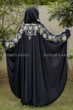 Black Kaftan Abaya in Nida Korean Fabric with Tilla Embroidery on Sleeves front side or at back side as well as motif on matching scarf.