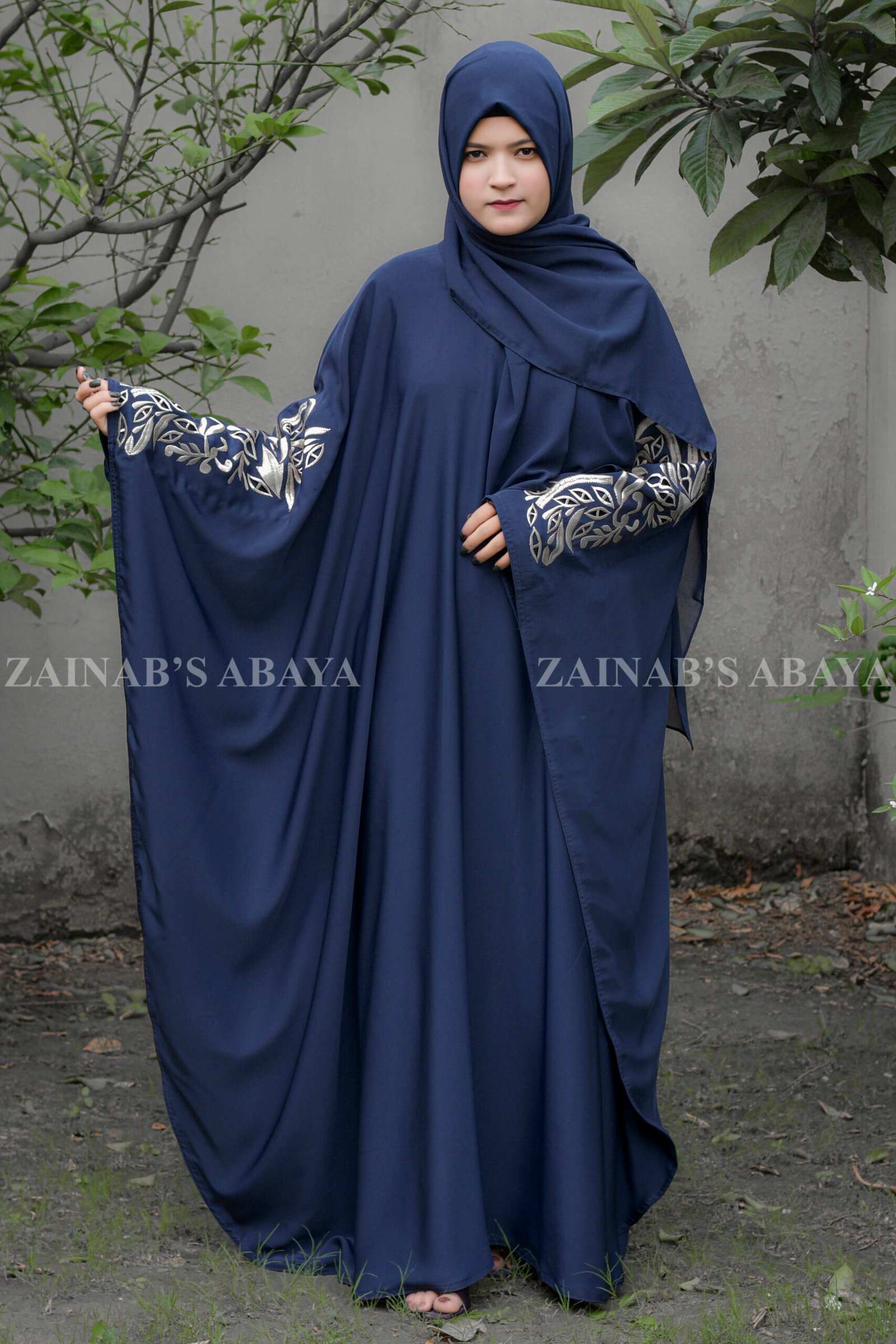 Navy Blue Kaftan Abaya with Embroidery - Zainab Designer Abaya.jpg Navy Blue Kaftan Abaya with Embroidery on Front Sleeves and Backside with a matching color scarf a motif on it