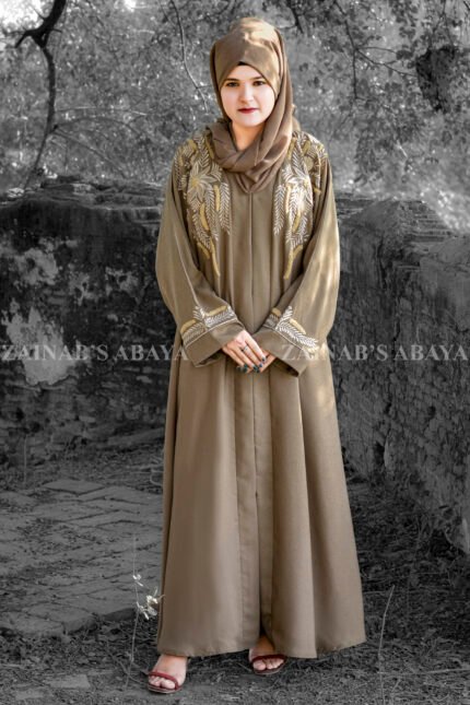 Front Open Abaya in Nida Korean Fabric featuring elegant embroidery on front sleeves cuffs and motif on the scarf. This abaya is in Skin Color