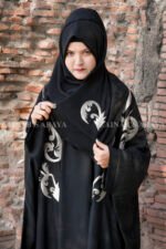 Black Kaftan Abaya In Nida Korean Fabric with Embroidery on it as well as motif on the scarf.