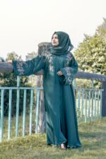 Front Open Abaya in Nida Korean with Embroidery on front and sleeve cuffs as well as motive on the scarf.