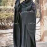 Black Kaftan Abaya in Nida Korean Fabric with Embroidery on sleeves and motif on scarf as well.