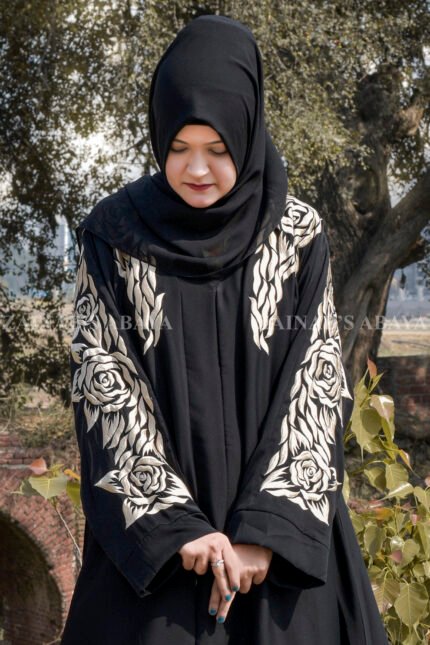 Black Front Open Abaya in Nida Korean Fabric with Sleek Designed Embroidery as well as motif on scarf.