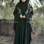 Black Kaftan Abaya In Nida Korean Fabric with Embroidery on it as well as motif on the scarf.