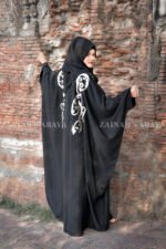 Black Kaftan Abaya In Nida Korean Fabric with Embroidery on it as well as motif on the scarf.