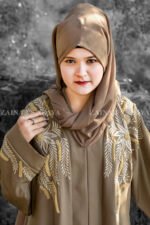 Front Open Abaya in Nida Korean Fabric featuring elegant embroidery on front sleeves cuffs and motif on the scarf. This abaya is in Skin Color