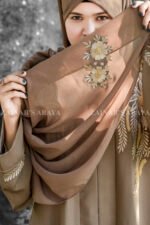 Front Open Abaya in Nida Korean Fabric featuring elegant embroidery on front sleeves cuffs and motif on the scarf. This abaya is in Skin Color