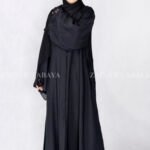 Black Front Open Abaya in Nida Korean Fabric with Elegant Embroidered and Cutwork on the sleeves cuffs as well as matching scarf in chiffon.