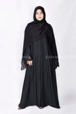 Black Front Open Abaya in Nida Korean Fabric with Elegant Embroidered and Cutwork on the sleeves cuffs as well as matching scarf in chiffon.