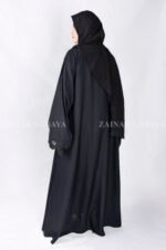 Black Front Open Abaya in Nida Korean Fabric with Elegant Embroidered and Cutwork on the sleeves cuffs as well as matching scarf in chiffon.