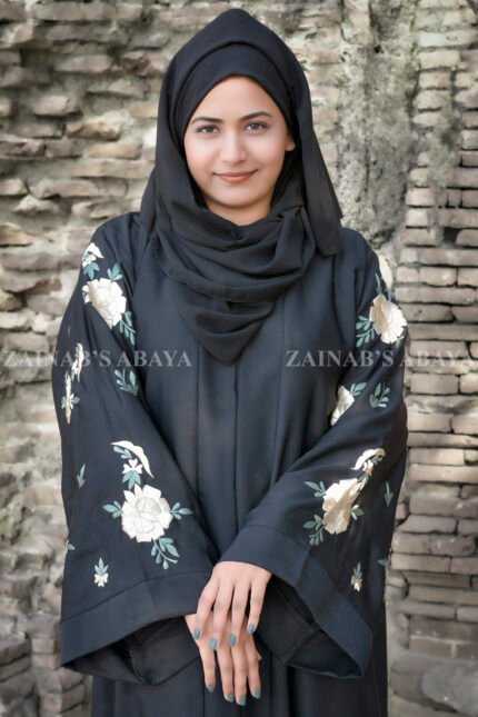 Front Open Abaya in Black Color which is crafted with premium Nida Korean fabric featuring the embroidery on sleeves and backside as well as a matching scarf in chiffon fabric.