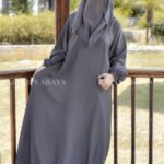 Grey Colored Maxi Abaya in Nida Korean Fabric featuring the elastic sleeves cuffs and a matching scarf in chiffon fabric.