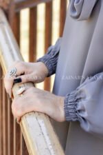 Grey Colored Maxi Abaya in Nida Korean Fabric featuring the elastic sleeves cuffs and a matching scarf in chiffon fabric.