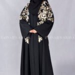 Nida Black Front Open Abaya with Embroidery Embellishment on Front, Back, Sleeves and motif on the scarf which is in Chiffon Fabric.