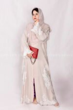 Front Open Abaya in Peach Color is crafted with premium Nida Korean Fabric featuring the embroidery at all around bottom, sleeves and motif on the scarf in same embroidery pattern which is in chiffon fabric.