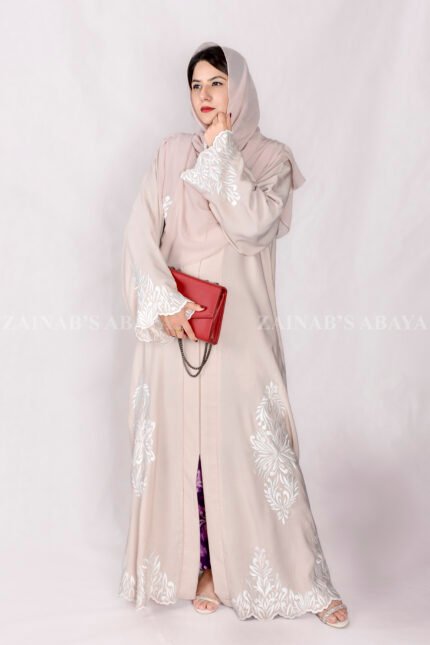 Front Open Abaya in Peach Color is crafted with premium Nida Korean Fabric featuring the embroidery at all around bottom, sleeves and motif on the scarf in same embroidery pattern which is in chiffon fabric.