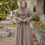 Front Open Abaya in Skin Color which is crafted in premium nida korean fabric featuring the button style on front stretchy elastic and plates style as well as a matching scarf in chiffon fabric.