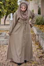 Front Open Abaya in Skin Color which is crafted in premium nida korean fabric featuring the button style on front stretchy elastic and plates style as well as a matching scarf in chiffon fabric.