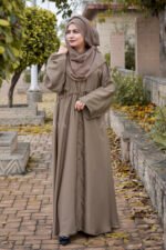 Front Open Abaya in Skin Color which is crafted in premium nida korean fabric featuring the button style on front stretchy elastic and plates style as well as a matching scarf in chiffon fabric.