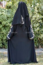 Black Front Open Abaya in Nida Korean Fabric with Embroidery and Piping on Front and Sleeves as well as motives on the scarf in same pattern which is in chiffon fabric.