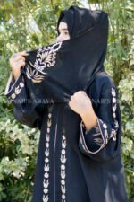 Black Front Open Abaya in Nida Korean Fabric with Embroidery and Piping on Front and Sleeves as well as motives on the scarf in same pattern which is in chiffon fabric.
