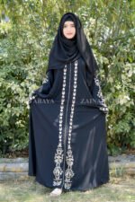 Black Front Open Abaya in Nida Korean Fabric with Embroidery and Piping on Front and Sleeves as well as motives on the scarf in same pattern which is in chiffon fabric.