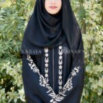 Black Front Open Abaya in Nida Korean Fabric with Embroidery and Piping on Front and Sleeves as well as motives on the scarf in same pattern which is in chiffon fabric.