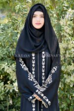 Black Front Open Abaya in Nida Korean Fabric with Embroidery and Piping on Front and Sleeves as well as motives on the scarf in same pattern which is in chiffon fabric.