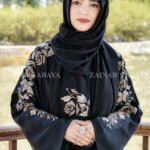Black Front Open Abaya in Nida Korean Fabric with Embroideyr on Sleeves, Back and Motif on the scarf in same embroidery pattern which is in chiffon fabric.