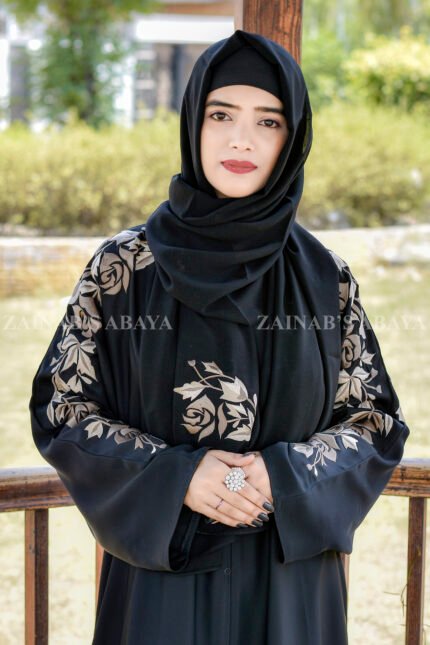 Black Front Open Abaya in Nida Korean Fabric with Embroideyr on Sleeves, Back and Motif on the scarf in same embroidery pattern which is in chiffon fabric.