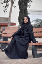 Black Maxi Abaya in Nida Korean Fabric featuring the strips and pearl work on front and sleeves as well as on scarf which is in chiffon fabric.