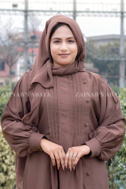 Maxi Abaya in Nida Korean Fabric featuring the plates on front upper button style at one side and cuff sleeves as well as a matching scarf in chiffon fabric.