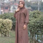 Maxi Abaya in Nida Korean Fabric featuring the plates on front upper button style at one side and cuff sleeves as well as a matching scarf in chiffon fabric.