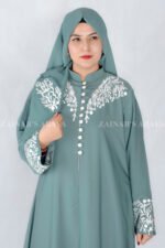 Nida Front Open Double Gown Abaya in Grape Color which is crafted in Premium Nida Korean Fabric featuring the stylish embroidery and button style on front and sleeves as well as a matching scarf in chiffon fabric with a same embroidery pattern motif .