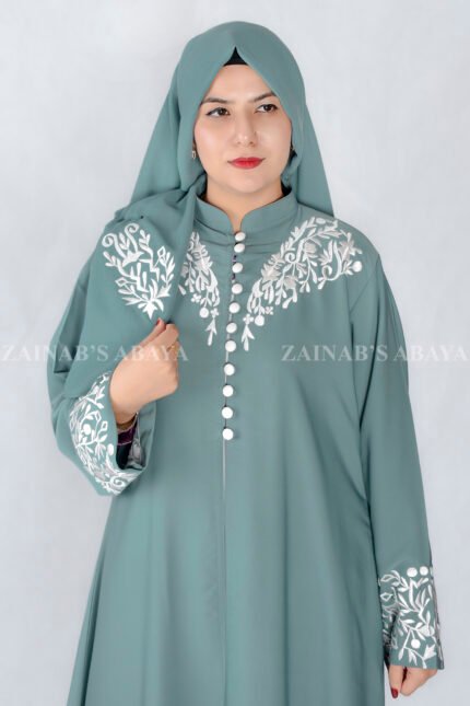 Nida Front Open Double Gown Abaya in Grape Color which is crafted in Premium Nida Korean Fabric featuring the stylish embroidery and button style on front and sleeves as well as a matching scarf in chiffon fabric with a same embroidery pattern motif .