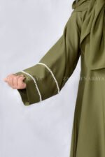 Maxi Abaya for Kids in Olive Green Color which is crafted in Premium Nida Korean Fabric with shiny pearl work on sleeves and at scarf as well which is in chiffon fabric.