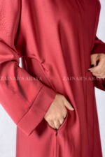 Red Colored Front Open Abaya is crafted in Premium Nida Korean Fabric with side pockets and a matching scarf in Chiffon Fabric.