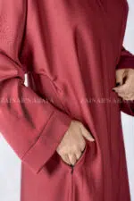 Red Colored Front Open Abaya is crafted in Premium Nida Korean Fabric with side pockets and a matching scarf in Chiffon Fabric.