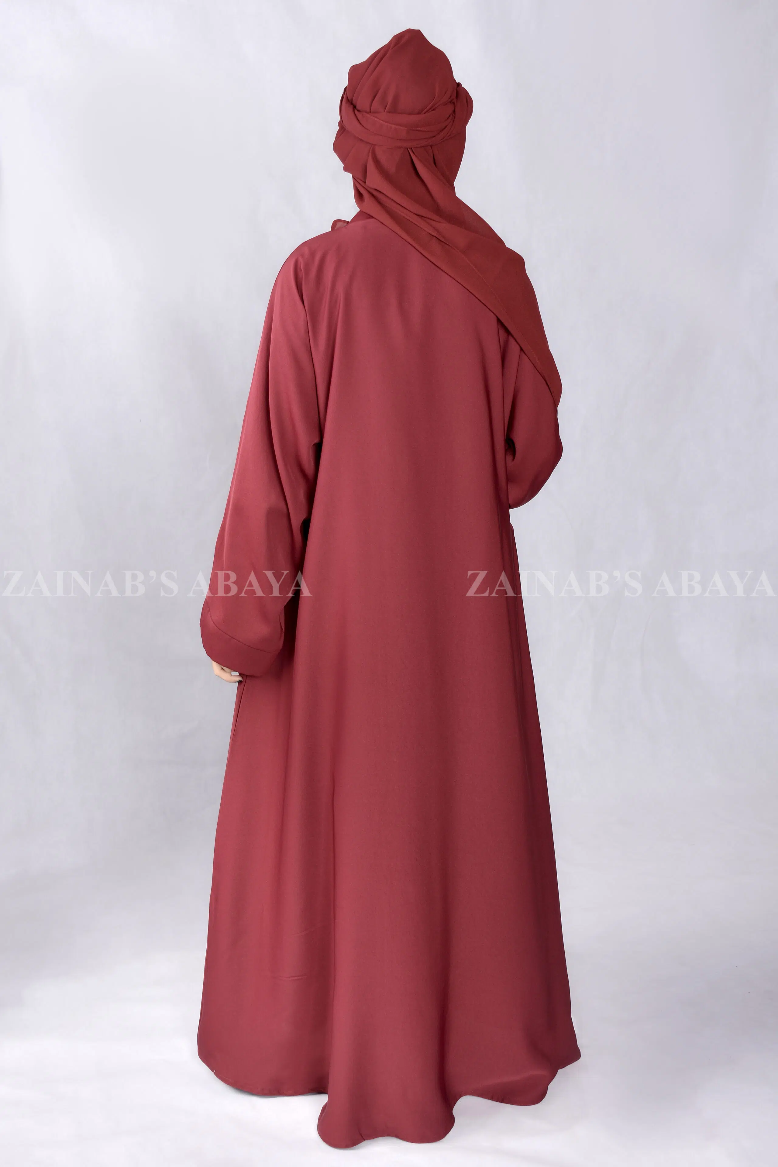 Red Colored Front Open Abaya is crafted in Premium Nida Korean Fabric with side pockets and a matching scarf in Chiffon Fabric.
