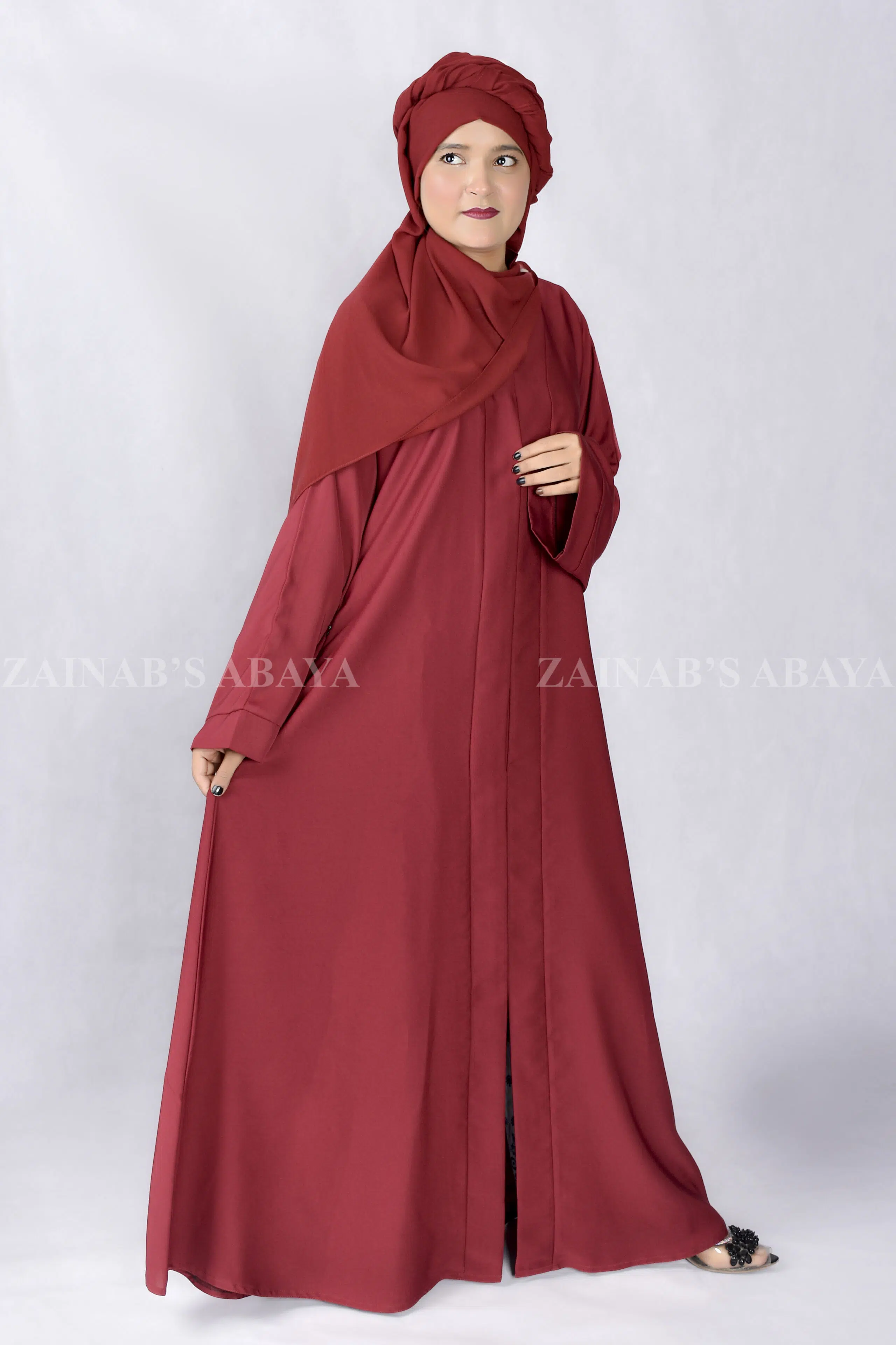 Red Colored Front Open Abaya is crafted with Imported Nida Korean Fabric with side pockets and a matching scarf in Chiffon Fabric.