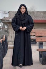 Black Maxi Abaya in Nida Korean Fabric featuring the strips and pearl work on front and sleeves as well as on scarf which is in chiffon fabric.
