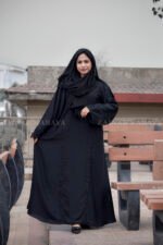 Black Maxi Abaya in Nida Korean Fabric featuring the strips and pearl work on front and sleeves as well as on scarf which is in chiffon fabric.