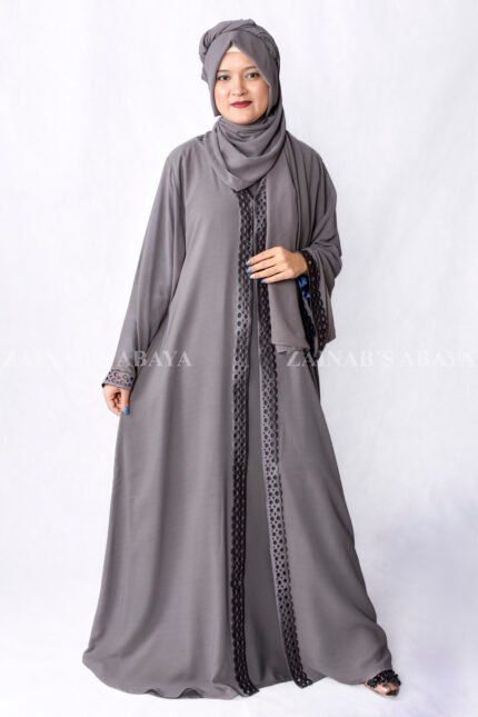Grey Colored Gown Abaya in Nida Korean Fabric featuring embroidery and cutwork on front borders and sleeves as well as same matching scarf in chiffon.