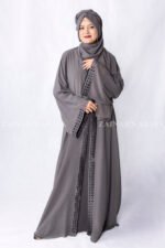 Grey Colored Gown Abaya in Nida Korean Fabric featuring embroidery and cutwork on front borders and sleeves as well as same matching scarf in chiffon.