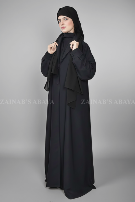 Black Coat Style Abaya for women in Nida Korean Fabric as well as matching scarf in chiffon fabric.