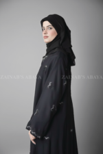 Black Maxi Abaya for women in Pakistan crafted with Premium Nida Korean Fabric featuring the bow style embroidery and stone work.